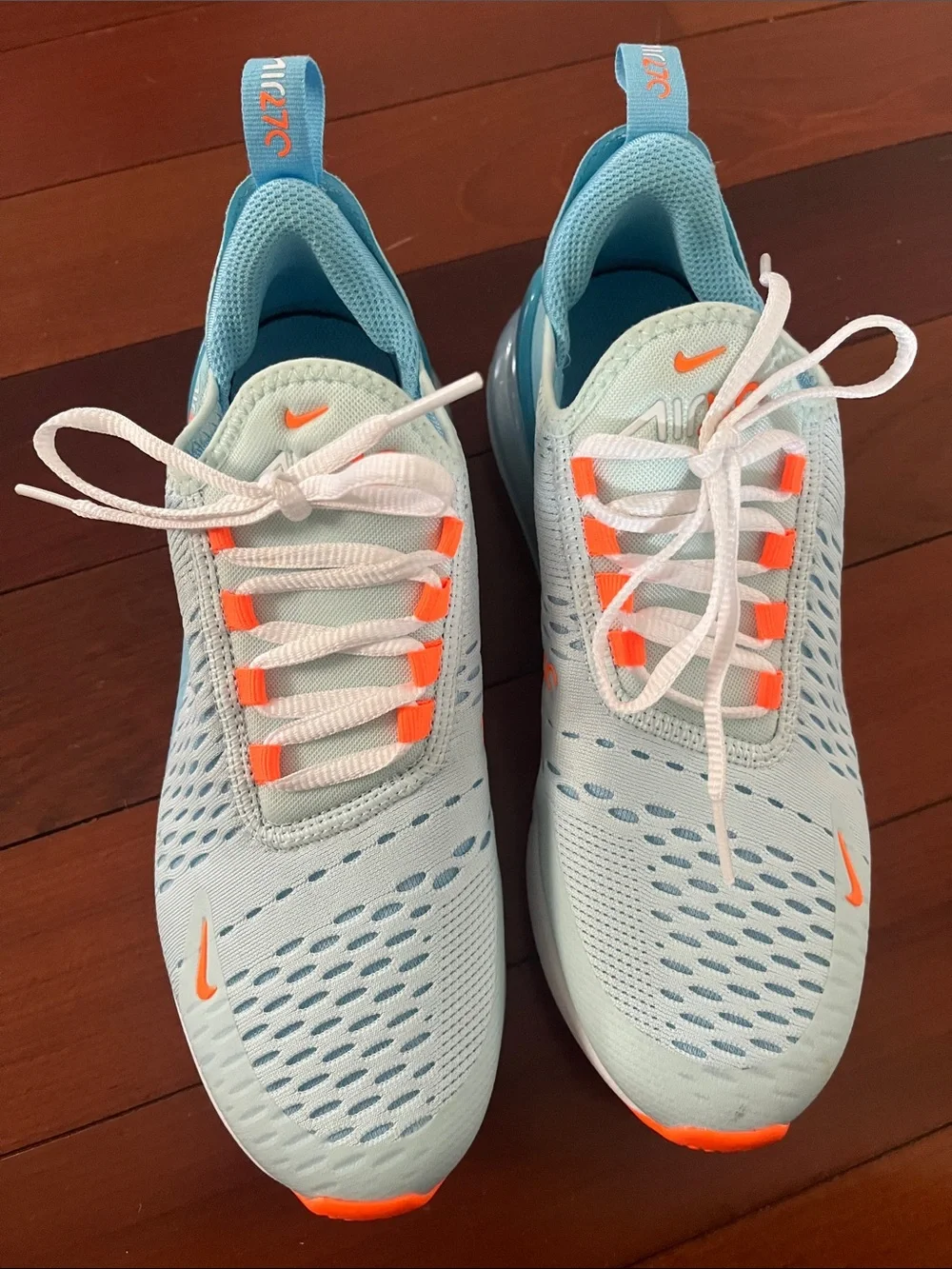 Nike Women’s Light Blue Sneakers with Orange Accents